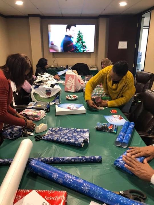 CCCoM wrapping Gifts for our Adopted Families
