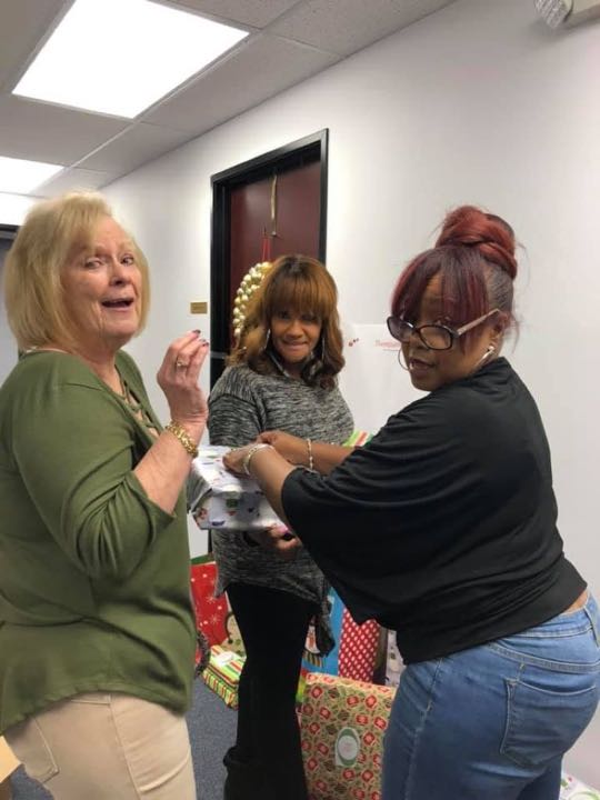 CCCoM wrapping gifts for our Adopted Families "Merry Christmas"