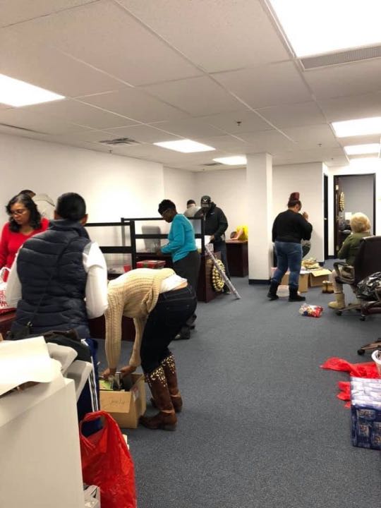 CCCoM wrapping gifts for our Adopted Families "Merry Christmas"