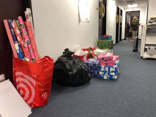 CCCoM wrapping gifts for our Adopted Families "Merry Christmas"