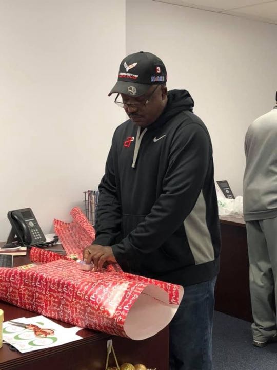 CCCoM wrapping gifts for our Adopted Families "Merry Christmas"