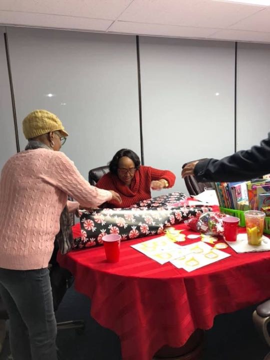 CCCoM wrapping gifts for our Adopted Families "Merry Christmas"