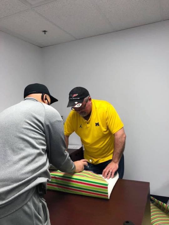CCCoM wrapping gifts for our Adopted Families "Merry Christmas"