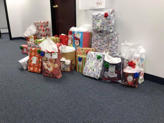 CCCoM wrapping gifts for our Adopted Families "Merry Christmas"